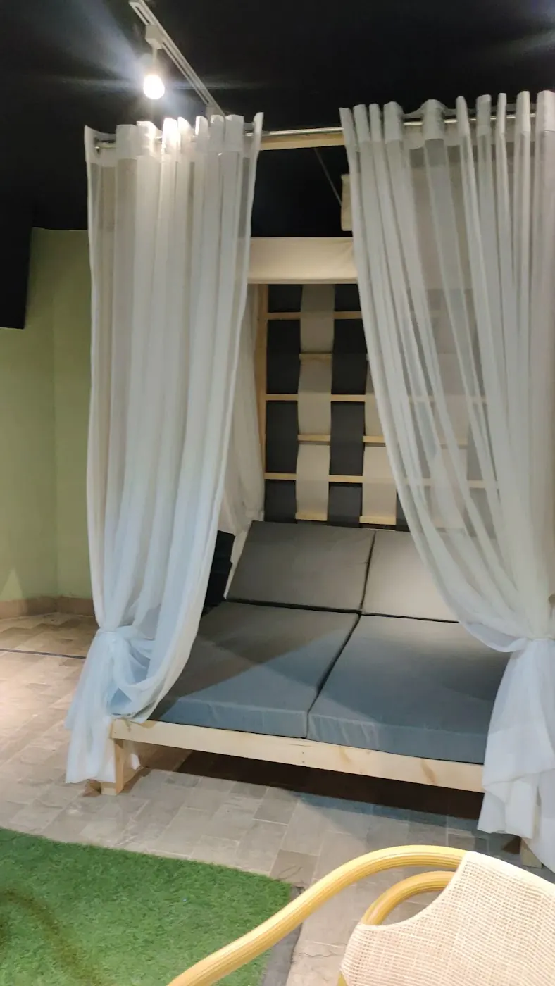 The cabana daybed with sheer curtains in the Wasi Craft showroom